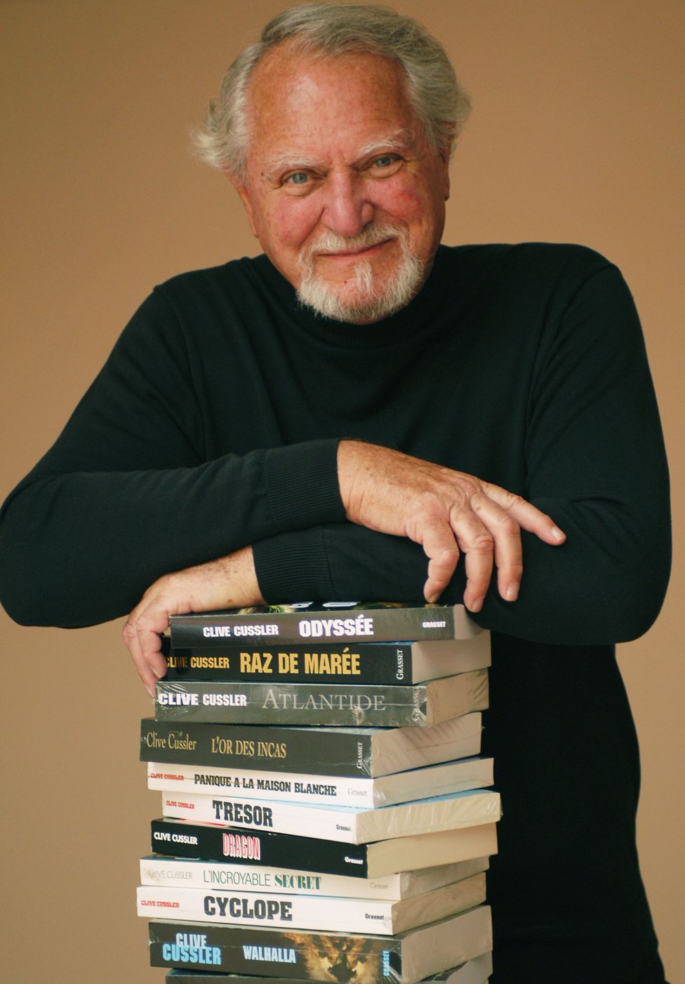 Clive Cussler with stack of books