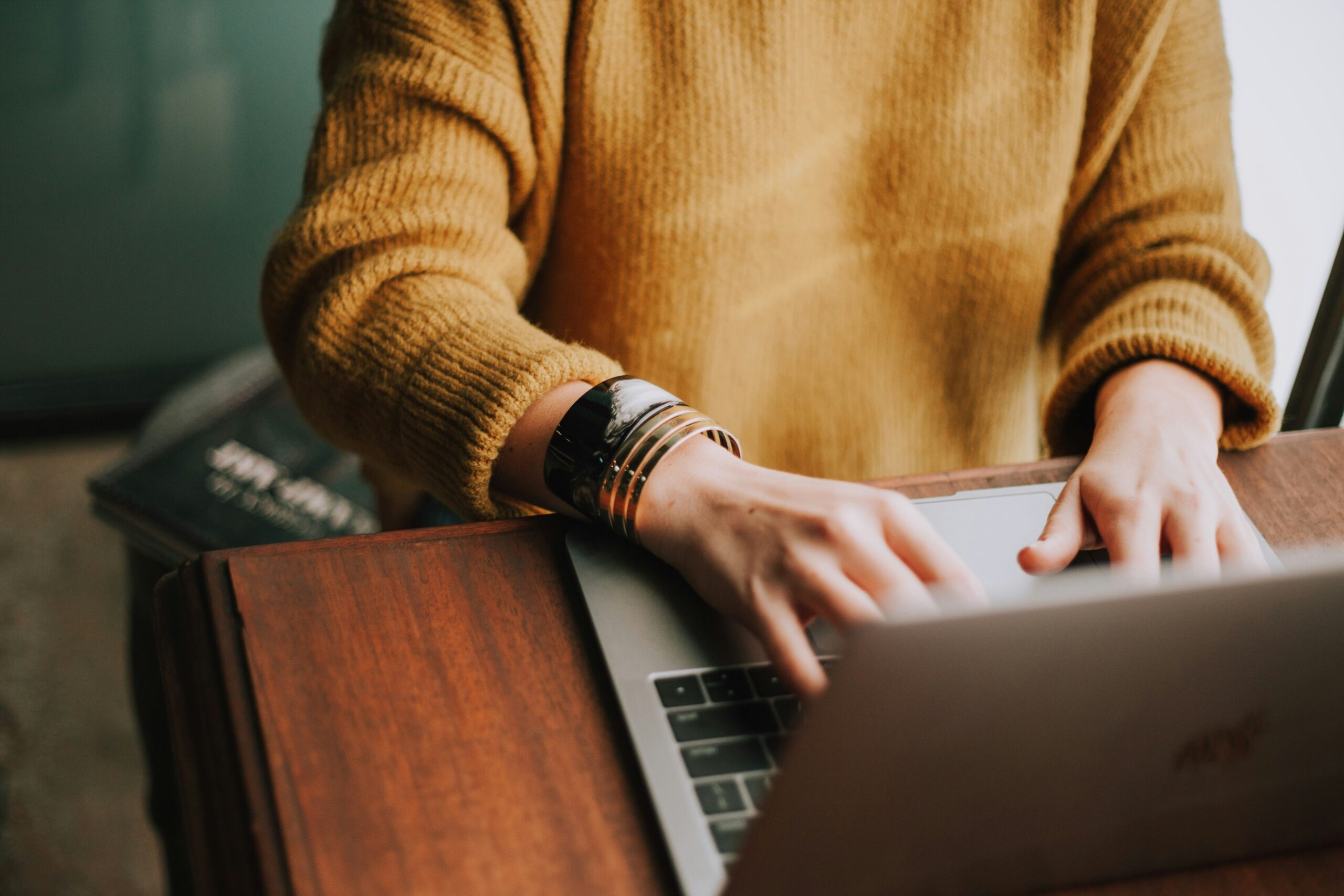 Photo of a lady's hands typing on laptop